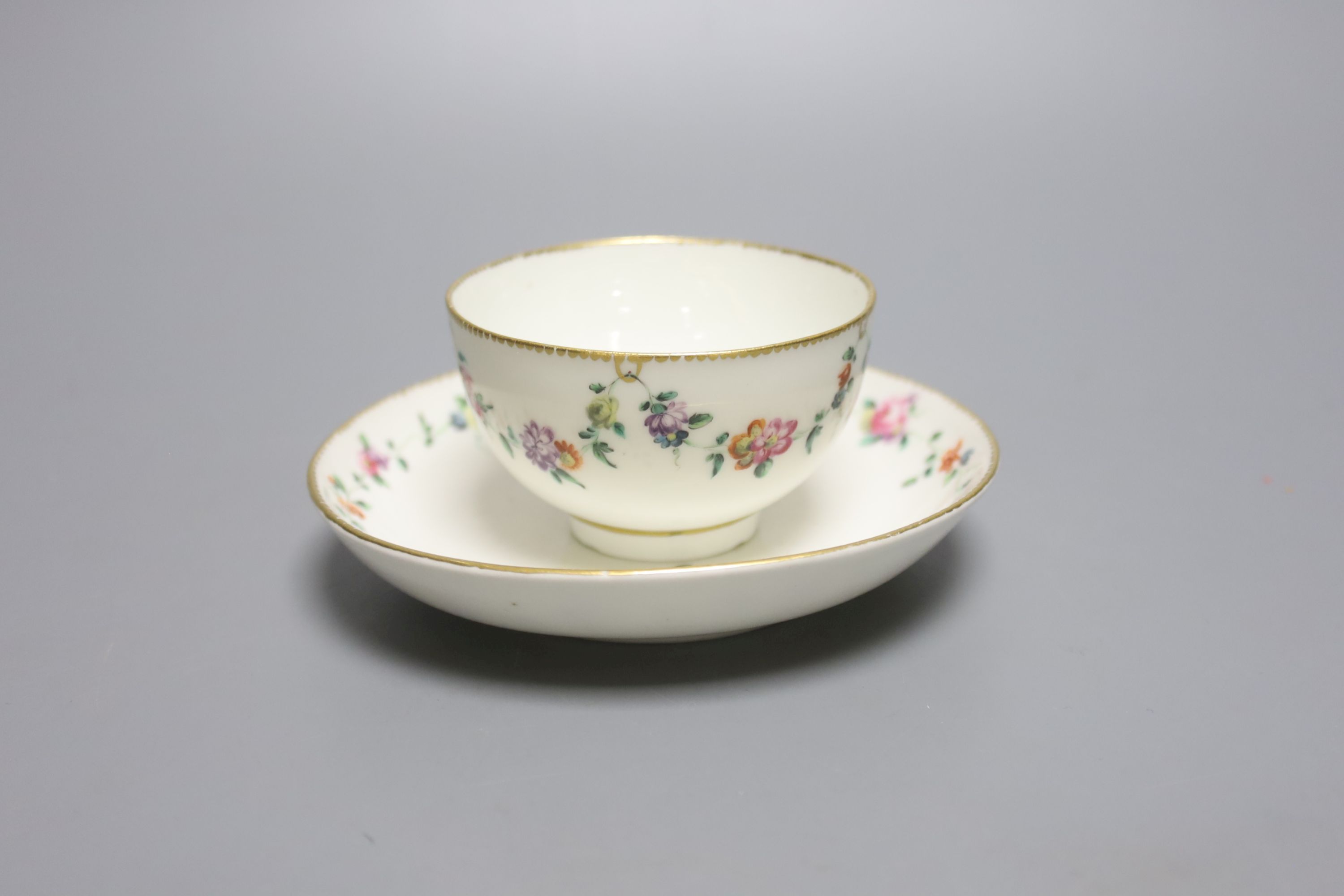 A Chelsea Derby teabowl and saucer painted with chains of flowers, anchor 'D' in gold, label for Alasdair Morrison c. 1775